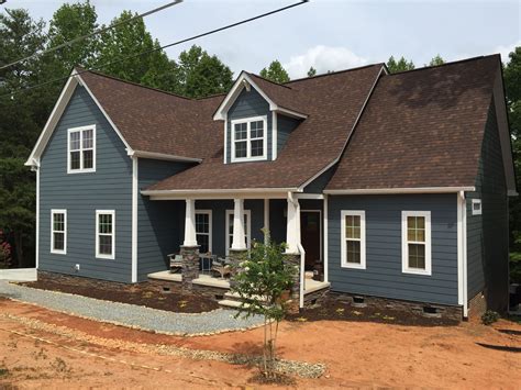 blue house with brown metal roof|deck colors for brown house.